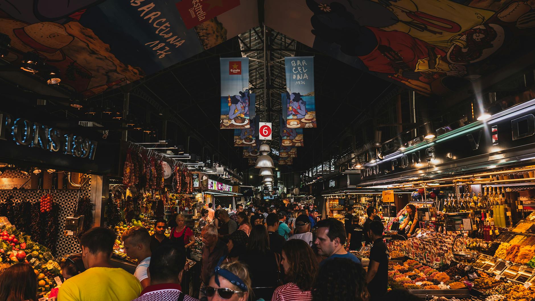 Mercado de La Boquería en Barcelona lleno de turistas, reflejando el impacto del turismo en espacios locales y la importancia de fomentar una experiencia más sostenible y respetuosa con la comunidad.